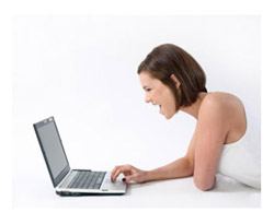 Woman laughing at computer