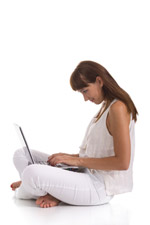 Woman sitting cross legged with a laptop on her lap