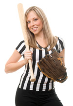 Woman in a referee uniform with a baseball and a bat